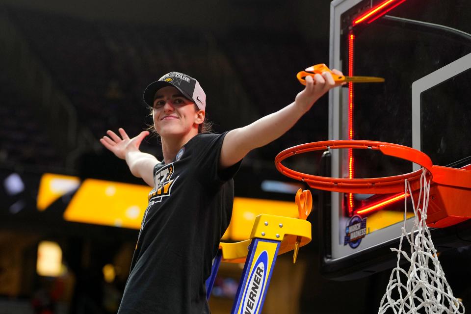 Iowa Hawkeyes guard Caitlin Clark (22) cuts the net after defeating the LSU Lady Tigers in the finals of the Albany Regional in the 2024 NCAA Tournament at MVP Arena.