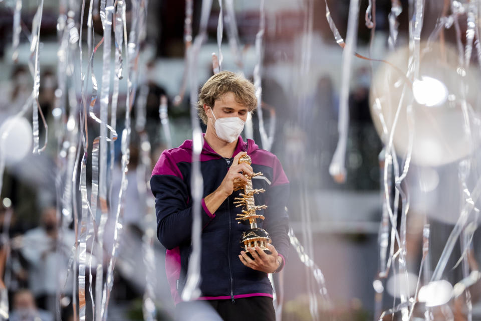 Germany's Alexander Zverev holds the trophy after winning the men's final match against Italy's Matteo Berrettini at the Mutua Madrid Open tennis tournament in Madrid, Spain, Sunday, May 9, 2021. (AP Photo/Bernat Armangue)