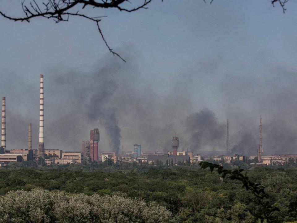 Smoke rises after a military strike on a compound of Sievierodonetsk’s Azot chemical plant, amid Russia’s attack on Ukraine, Lysychansk, Luhansk region on 10 June (Reuters)