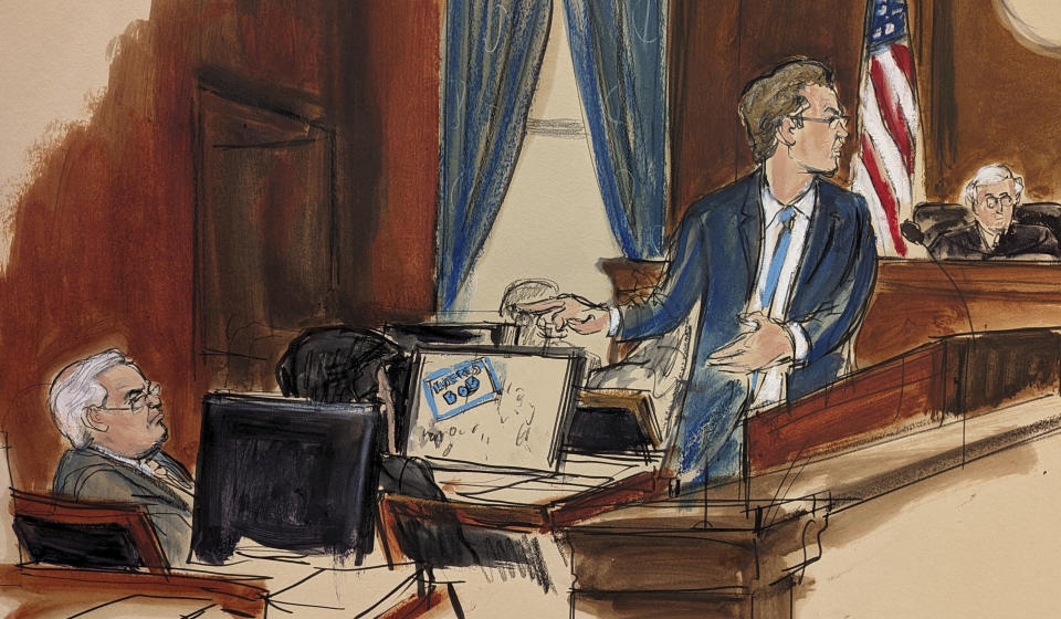 In this courtroom sketch, U.S. Sen. Robert Menendez, seated far left, looks at his defense attorney Avi Weitzman give his opening statement during his trial Wednesday, May 15, 2024, in New York. Judge Sidney Stein is presiding. (Elizabeth Williams via AP)