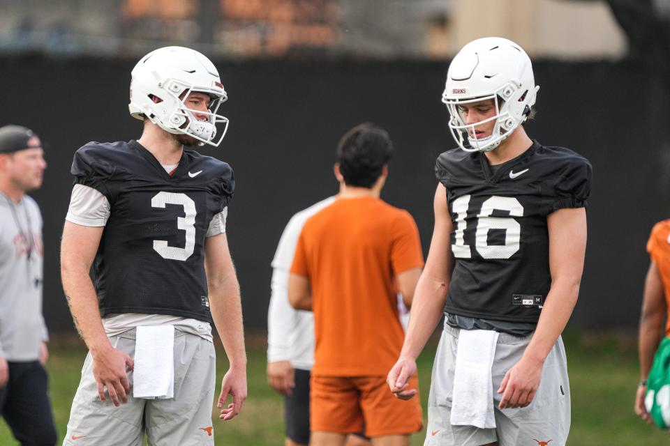 Texas quarterbacks Arch Manning (16) and Quinn Ewers talk during the team's first spring practice of 2023 at the Frank Denius Fields.