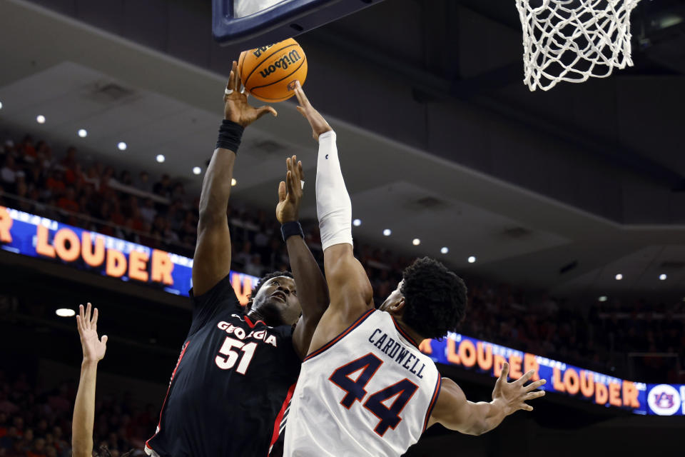 Georgia center Russel Tchewa (51) shoots against Auburn center Dylan Cardwell (44) during the first half of an NCAA college basketball game Saturday, March 9, 2024, in Auburn, Ala. (AP Photo/ Butch Dill)