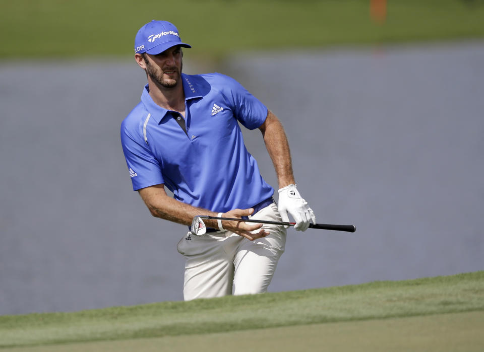 Dustin Johnson watches his shot on the ninth hole during a practice round of the Cadillac Championship golf tournament, Wednesday, March 5, 2014 in Doral, Fla. (AP Photo/Wilfredo Lee)