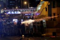 Riot police fire tear gas at demonstrators during a protest against police violence in Hong Kong