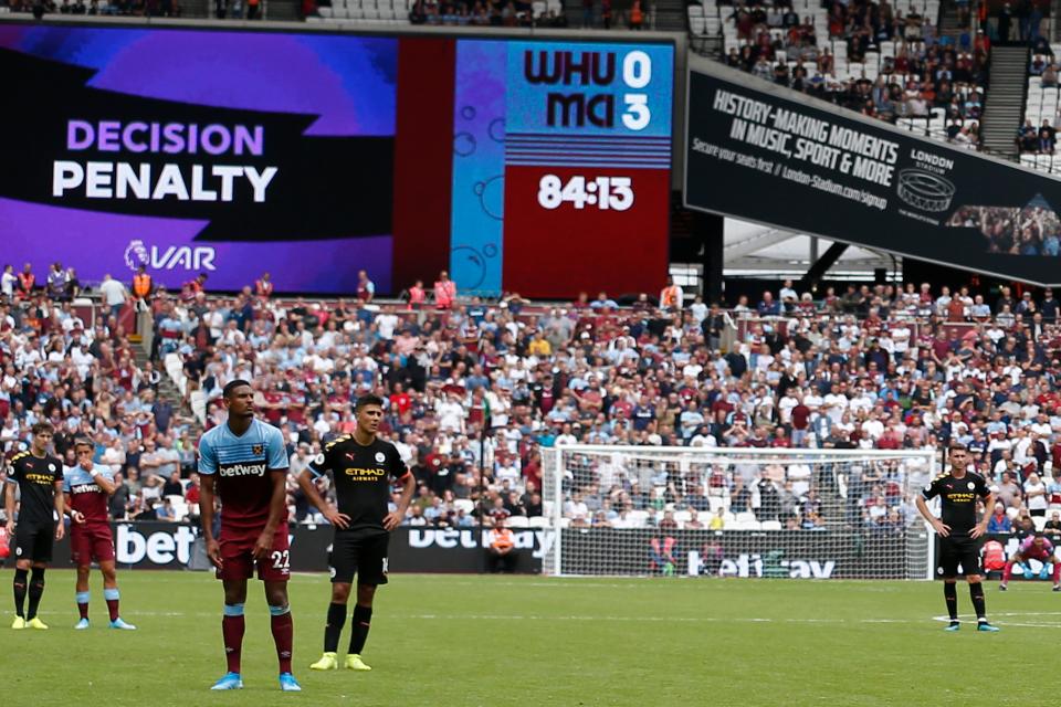 The big screen displays the VAR decision ruling that a Manchester City penalty, that on the first attempt was saved, must be retaken during the English Premier League football match between West Ham United and Manchester City at The London Stadium, in east London on August 10, 2019. (Photo by Ian KINGTON / AFP) / RESTRICTED TO EDITORIAL USE. No use with unauthorized audio, video, data, fixture lists, club/league logos or 'live' services. Online in-match use limited to 120 images. An additional 40 images may be used in extra time. No video emulation. Social media in-match use limited to 120 images. An additional 40 images may be used in extra time. No use in betting publications, games or single club/league/player publications. /         (Photo credit should read IAN KINGTON/AFP/Getty Images)