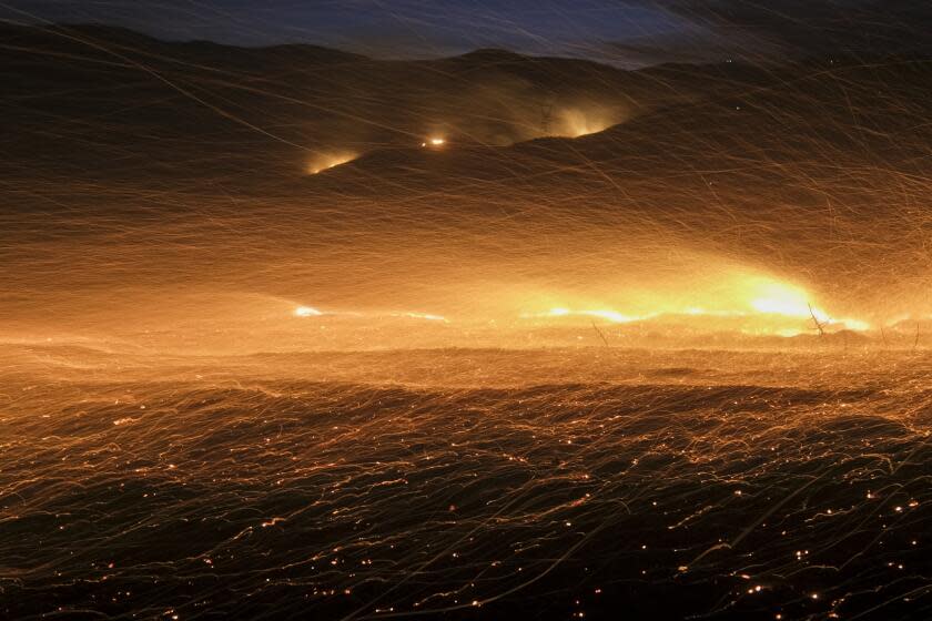 Wind whips embers from a hotspot during a wildfire in Castaic, Calif. on Wednesday, Aug. 31, 2022. (AP Photo/Ringo H.W. Chiu)