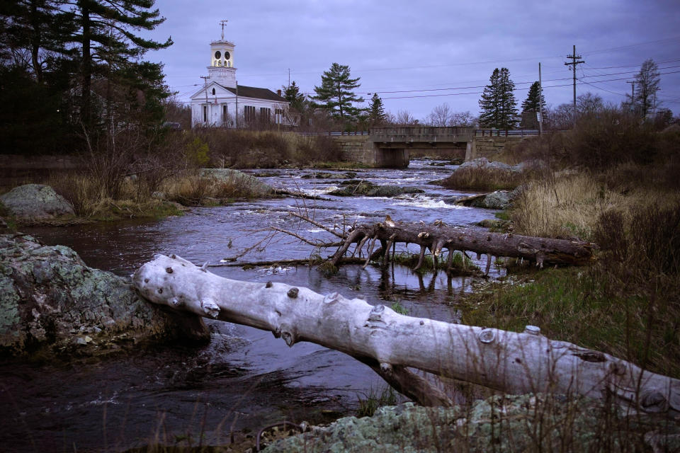 The Pleasant River flows through Columbia Falls, Maine, Thursday, April 27, 2023. (AP Photo/Robert F. Bukaty)