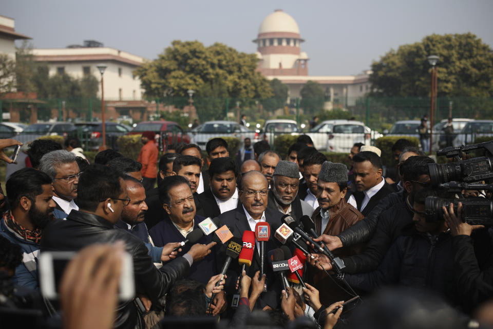 Indian Union Muslim League leader P.K.Kunhalikutty, center, one of the petitioners, speaks to media on the lawns of India's Supreme Court after the top court started hearing dozens of petitions that seek revocation of a new citizenship law amendment in New Delhi, India, Wednesday, Jan. 22, 2020. The new law had led to nationwide demonstrations and a violent security backlash resulting in the death of more than 20 people. (AP Photo/Altaf Qadri)