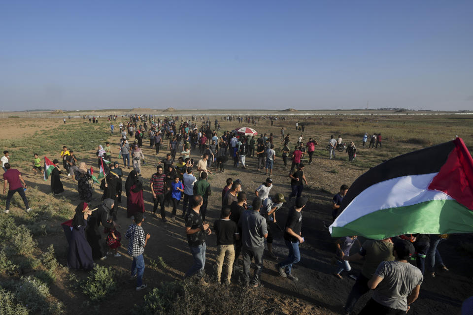 Palestinian protesters gather during clashes with Israeli troops, along the frontier with Israel, east of Gaza City, Monday, Aug. 21, 2023. Hundreds of Palestinians protested near the border fence with Israel. The Gaza Health Ministry said at least eight people were wounded by Israeli fire and tear gas. (AP Photo/Adel Hana)