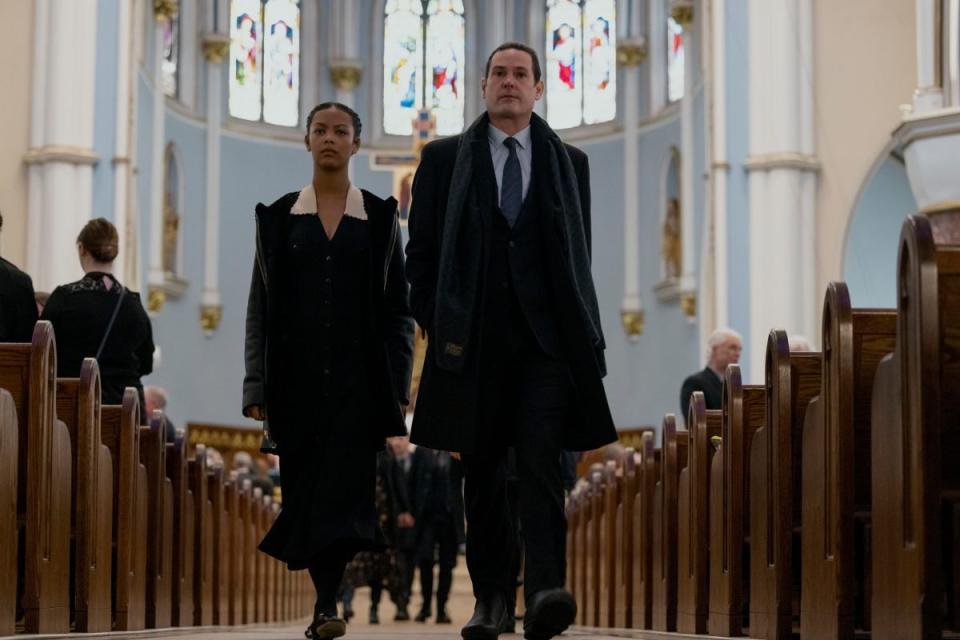 A man and woman walk down a church aisle in The Fall Of The House Of Usher