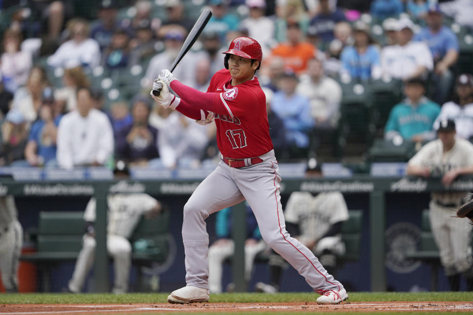 Los Angeles Angels' Shohei Ohtani follows through on a line-out to left field during the first inning of the first baseball game of a doubleheader against the Seattle Mariners, Saturday, June 18, 2022, in Seattle. (AP Photo/Ted S. Warren)