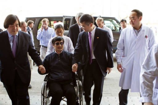 This file photo, from the US Embassy Beijing Press office, taken on May 2, shows Chinese dissident Chen Guangcheng (C), being accompanied by US ambassador to China Gary Locke (2nd R), in Beijing. Chen said on Thursday China had agreed to issue him a passport within 15 days, allowing him to go to the US, after a bitter row between Beijing and Washington