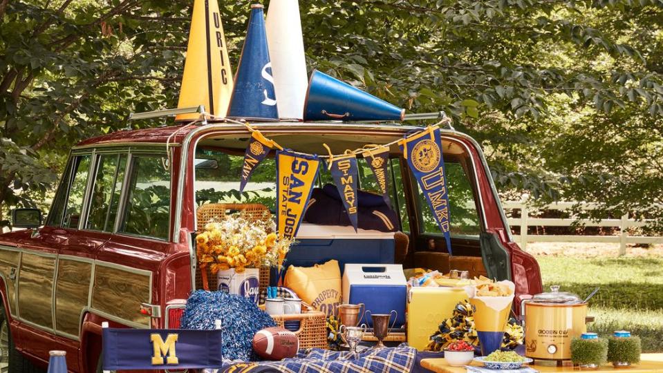 1984 grand wagoneer tailgating party with food and football memorabilia