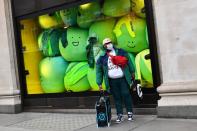 A man wears a mask while shopping in London