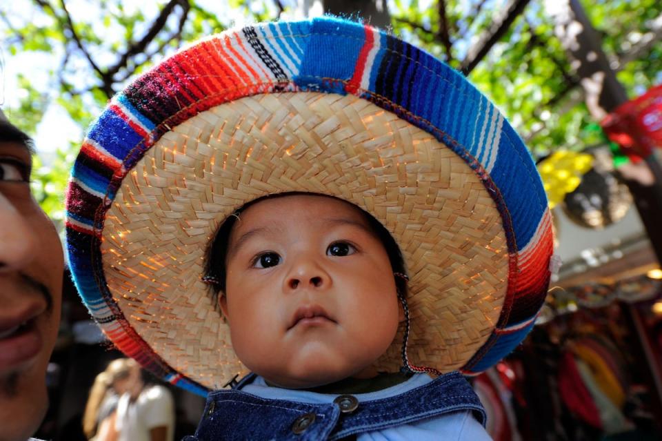 Baby Alexander and his father Alfonso Mendoza attend Cinco de Mayo festivities at El Pueblo de Los Angeles (Kevork Djansezian / Getty Images)