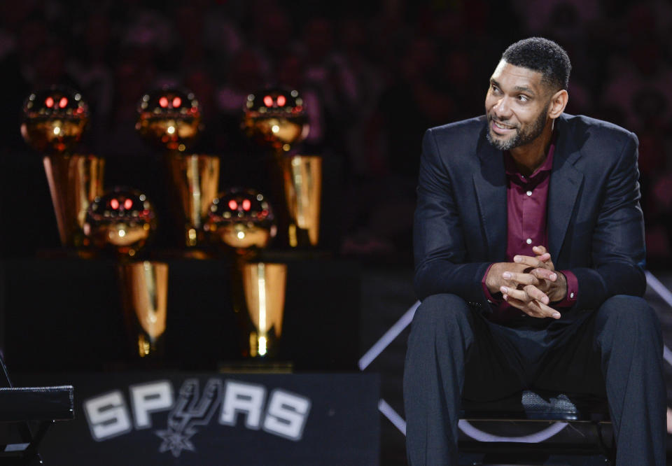 FILE - In this Dec. 18, 2016, file photo, San Antonio Spurs' Tim Duncan listens while special guests speak about him during his jersey retirement ceremony, in San Antonio. The Spurs have watched franchises in Cleveland, Los Angeles, Boston, Chicago and elsewhere bottom out after losing a foundational star. Their mission has been to avoid a similar fate after Tim Duncan’s retirement. Not only have they not bottomed out, they enter the Western Conference playoffs eyeing a sixth championship.(AP Photo/Darren Abate, File)