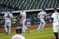 Los Angeles Dodgers relief pitcher Joe Kelly, second from left, talks back to Houston Astros' Carlos Correa (1) after the sixth inning of a baseball game Tuesday, July 28, 2020, in Houston. Both benches emptied onto the field during the exchange. (AP Photo/David J. Phillip)