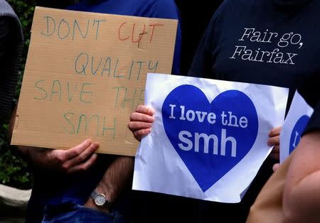 Fairfax journalists hold placards and wear shirts displaying slogans during a protest regarding the announcement of further staff cuts to the Sydney Morning Herald (SMH) and Melbourne Age newspapers in central Sydney, Australia, May 4, 2017. REUTERS/David Gray