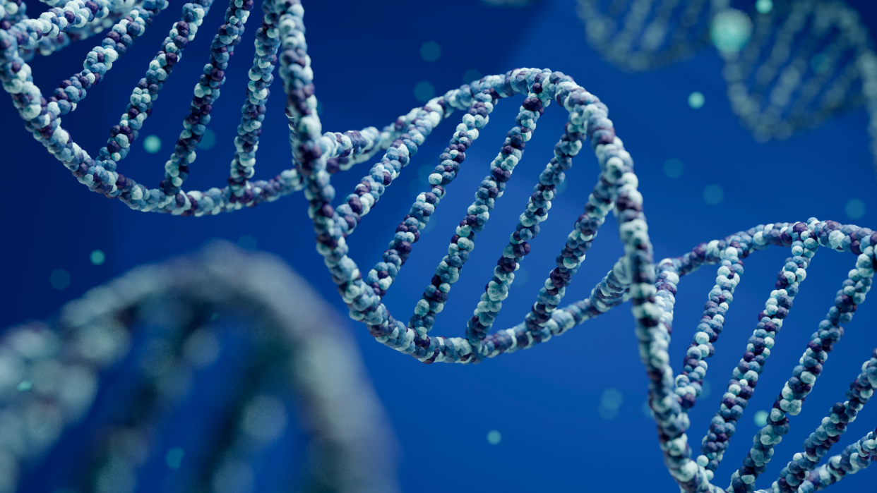  Illustration of a DNA double helix against a blue background. Two other helices can be seen blurred in the background. 