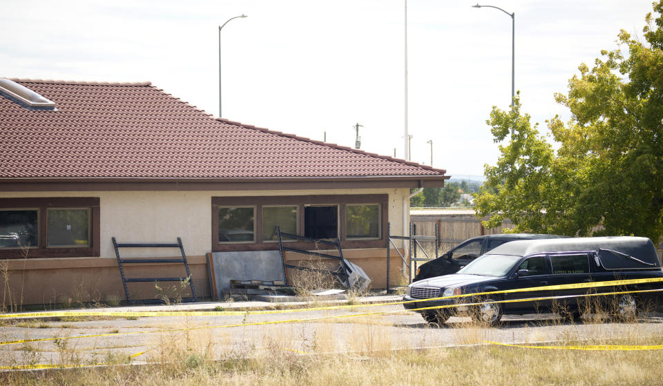 FILE - A hearse and van sit outside the Return to Nature Funeral Home, Oct. 6, 2023, in Penrose, Colo. Jon and Carie Halfford, who are accused of storing 200 decaying bodies and sending families fake ashes last year, are set to enter pleas in court on Thursday, March 21, 2024. (AP Photo/David Zalubowski, File)