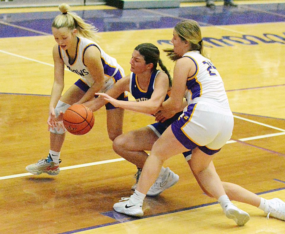 Watertown's Addi Johnston (left) and Jade Lund attempt to take the ball away from Sioux Falls O'Gorman's Kira Mentele during their high school girls basketball game Friday night in the Civic Arena. O'Gorman won 50-42.