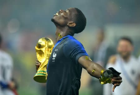 Soccer Football - World Cup - Final - France v Croatia - Luzhniki Stadium, Moscow, Russia - July 15, 2018 France's Paul Pogba holds the trophy as he celebrates winning the World Cup REUTERS/Dylan Martinez