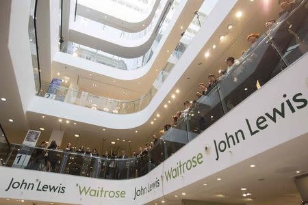 John Lewis and Waitrose employees wait for the announcement of their 2015 bonus in central London, March 12, 2015. REUTERS/Neil Hall