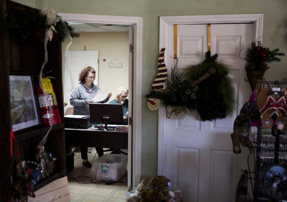 Joe Thomas, right, and his wife Patti, work in the office of their floral shop in Lula, Ga., in Hall County, Tuesday, Jan. 10, 2017. Joe praised Trump as a "non-politician" who "doesn't have to answer to" establishment players. Patti said that style spoke to non-urban dwellers who see a country increasingly dominated and defined by cities. The fact that Trump himself is from New York City doesn't matter. He added, "No one else in this election had that force of personality." (AP Photo/David Goldman)