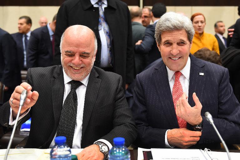 US Secretary of State John Kerry (right) sits next to Iraqi Prime Minister Haider al-Abadi during talks at the NATO headquarters in Brussels, on December 3, 2014