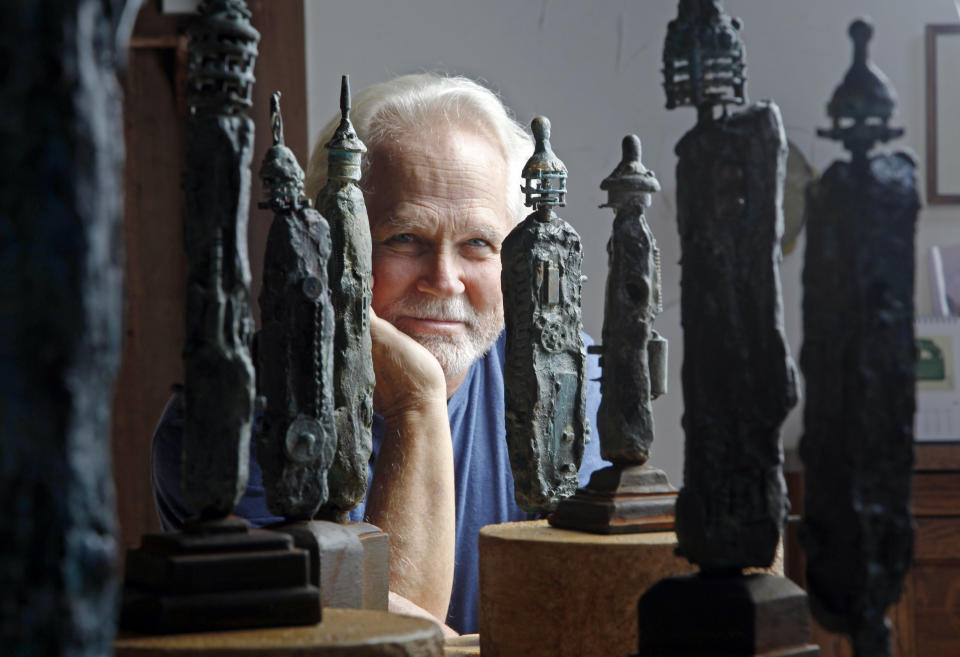 FILE - Tony Dow, actor, director and artist, poses with some of his works at his home and studio in the Topanga area of Los Angeles, Thursday, Sept. 18, 2012. “Leave It to Beaver” actor Dow has died at age 77. Frank Bilotta, who represented Dow in his work as a sculptor, confirmed his death in an email to The Associated Press on Wednesday, July 27, 2022. (AP Photo/Reed Saxon, File)