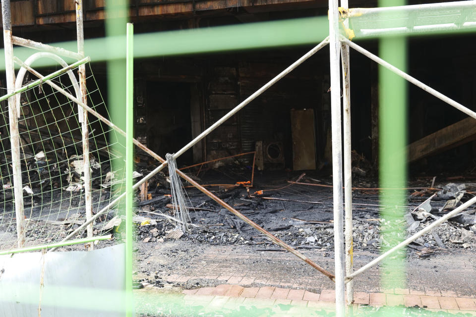 A burnt building is pictured in Kaohsiung in southern Taiwan on Friday, Oct. 15, 2021. Dozens were killed and dozens more injured after a fire broke out early Thursday in a decades-old mixed commercial and residential building in the Taiwanese port city of Kaohsiung, officials said. (AP Photo/Huizhong Wu)