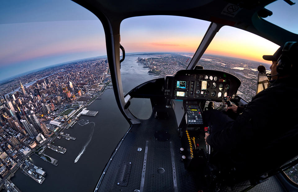 <p>The series required Andrew and his crew to fly over key locations around the city and have Andrew lean out as far as possible to photograph the city life below. (Photo: Andrew Griffiths/Lensaloft/Caters) </p>