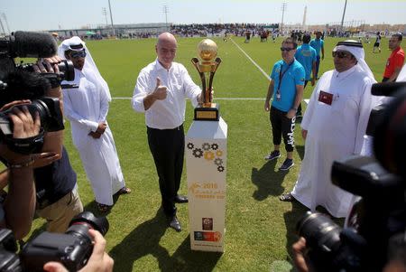 FIFA's newly elected president Gianni Infantino poses with the Qatar Workers Cup trophy in Doha, Qatar, April 22, 2016. REUTERS/Naseem Zeitoon