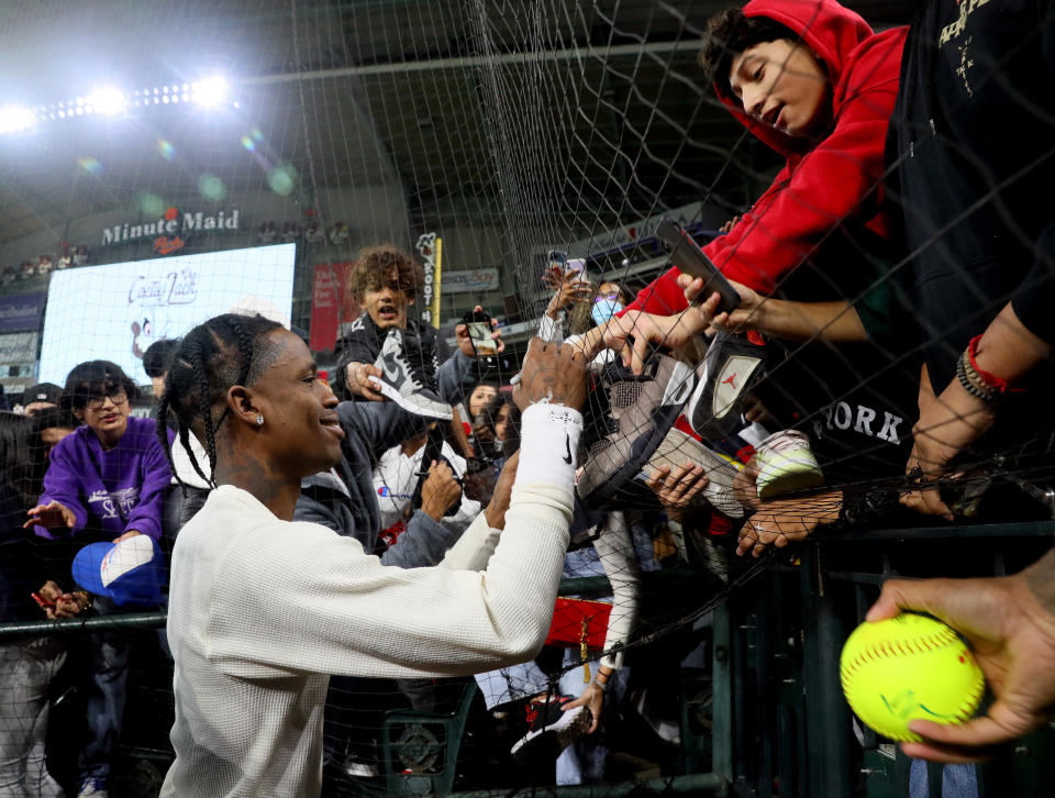 HOUSTON, TEXAS - NOVEMBER 04: Travis Scott signs autographs for fans during the 2021 Cactus Jack Foundation fall classic softball game at Minute Maid Park on November 04, 2021 in Houston, Texas. (Photo by Bob Levey/Getty Images)