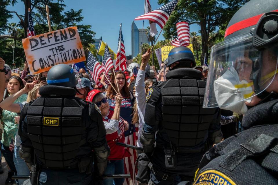 Protesters demonstrate at the Capitol in Sacramento on Friday, May 1, 2020, against Gov. Gavin Newsoms stay-at-home order to slow the spread of the coronavirus.