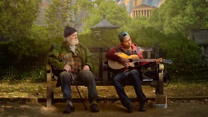 Nick Nolte and Dharon Jones sitting on a bench