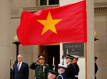 A Vietnam flag flies as U.S. Defense Secretary Jim Mattis (L) hosts an honor cordon for Vietnamese Defense Minister Gen. Ngo Xuan Lich (R) at the Pentagon in Arlington, Virginia, U.S., August 8, 2017. REUTERS/Kevin Lamarque