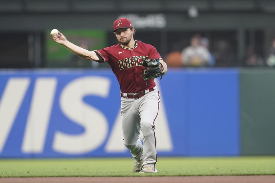 Arizona Diamondbacks second baseman Buddy Kennedy throws out San Francisco Giants' Joc Pederson at first base during the fourth inning of a baseball game in San Francisco, Monday, July 11, 2022. (AP Photo/Jeff Chiu)