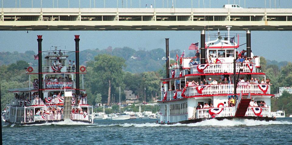 The Tom Sawyer and the Island Queen battle it out during the riverboat race at Tall Stacks in 1999.