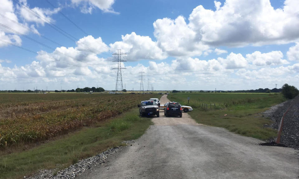 <p>Police cars block access to the site where a hot air balloon crashed, July 30, 2016, near Lockhart, Texas. (AP Photo/James Vertuno)</p>