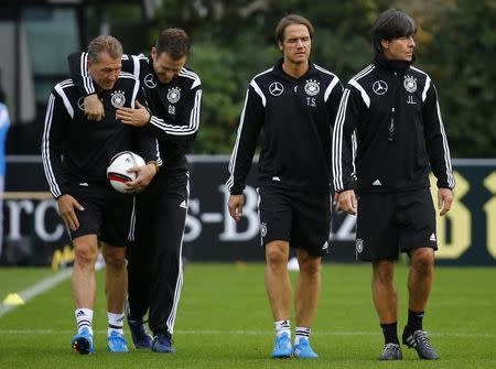 German national soccer team's goalkeeper coach Andreas Koepke, manager Oliver Bierhoff, coach assistant Thomas Schneider and coach Joachim Loew (L-R) walk during the team's training in Frankfurt October 7, 2014. REUTERS/Kai Pfaffenbach