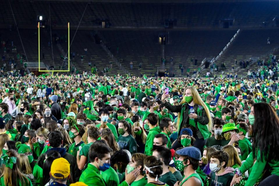 Nov 7, 2020; South Bend, Indiana, USA; Fans storm the field after the Notre Dame Fighting Irish defeated the Clemson Tigers 47-40 in two overtimes. Mandatory Credit: Matt Cashore-USA TODAY Sports