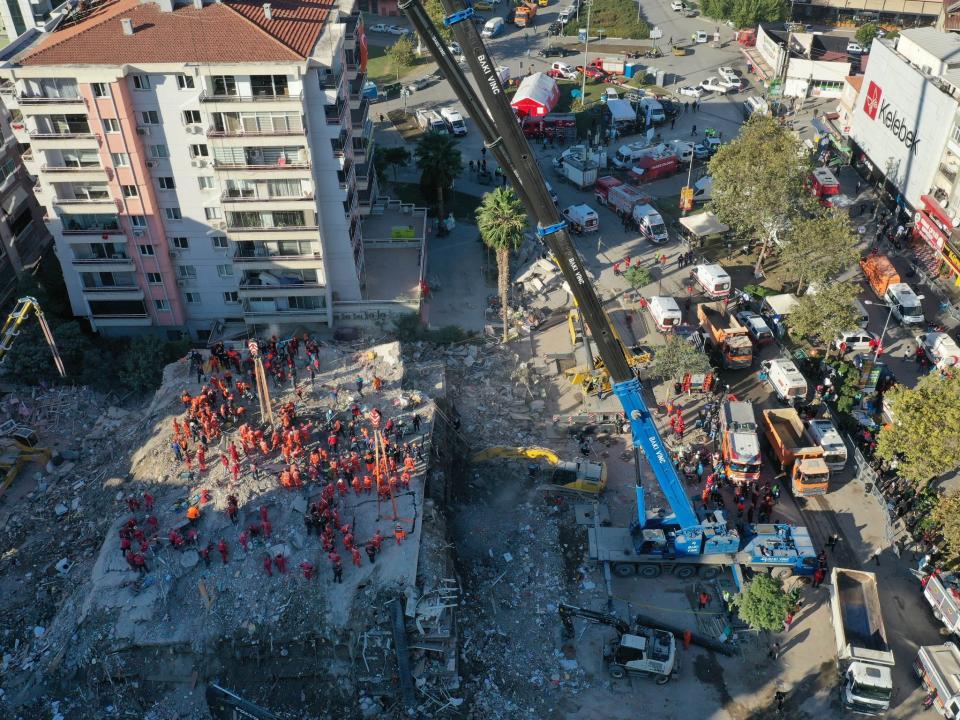 <p>Aerial view of search and rescue workers in the morning hours at debris located in Bayrakli district, Izmir, Turkey on 1 November, 2020</p>Anadolu Agency via Getty Images