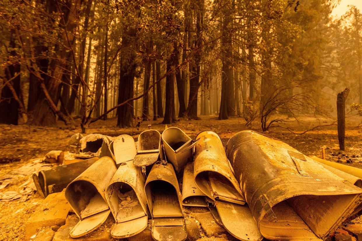 Scorched mailboxes lie on the ground after the Dixie Fire passed through the Indian Falls community of Plumas County, Calif. on Sunday, July 25, 2021.