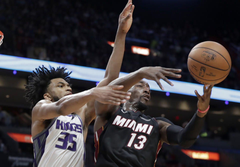 Sacramento Kings forward Marvin Bagley III (35) and Miami Heat center Bam Adebayo (13) go for a loose ball during the first half of an NBA basketball game, Monday, Jan. 20, 2020, in Miami. (AP Photo/Lynne Sladky)