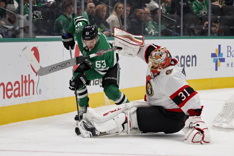 Dallas Stars right wing Evgenii Dadonov (63) tries to get the puck as Ottawa Senators goaltender Anton Forsberg (31) defends during the first period of an NHL hockey game in Dallas, Friday, Dec. 15, 2023. (AP Photo/Michael Ainsworth)