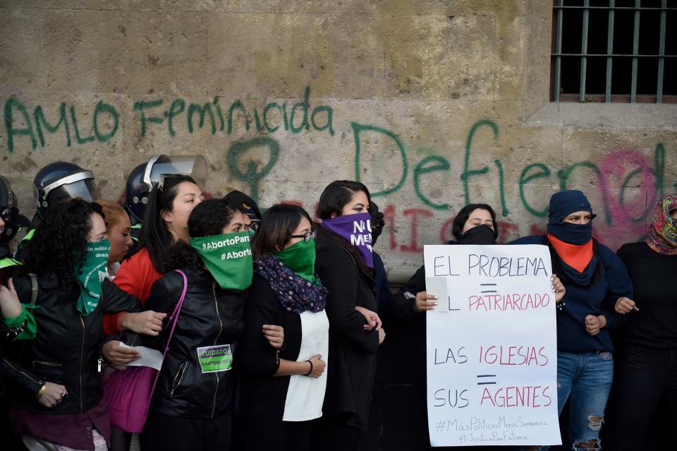 Demonstrators gather outside the National Palace, in Mexico City, on February 18, 2020, to protest gender violence. - Dozens of women protested Tuesday over the murder of a seven-year-old girl in the Mexican capital, a case that generated anger and outrage in a country used to violence. The murder of the minor shocked the country two days after hundreds of women protested in several cities in Mexico over the femicide of Ingrid Escamilla, a 25-year-old woman who was killed by her partner north of the Mexican capital. (Photo by ALFREDO ESTRELLA / AFP) (Photo by ALFREDO ESTRELLA/AFP via Getty Images)