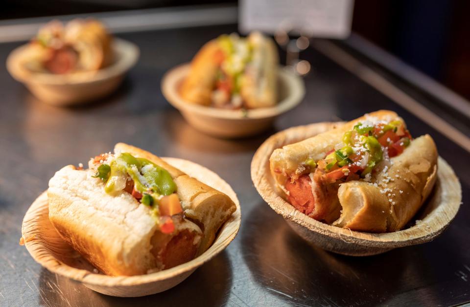 Plates of the Sonoran Hot Dog are placed on a counter for guests during the annual What's New at Comerica Park event in Detroit on Friday, March 31, 2023. 