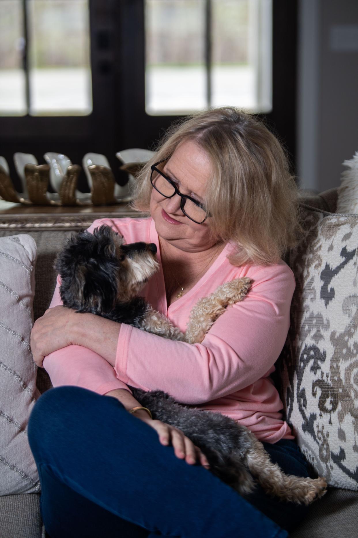 Chonda Pierce cuddles with her dog Murphy at her home in Ashland City, Tenn., Tuesday, April 9, 2024.
