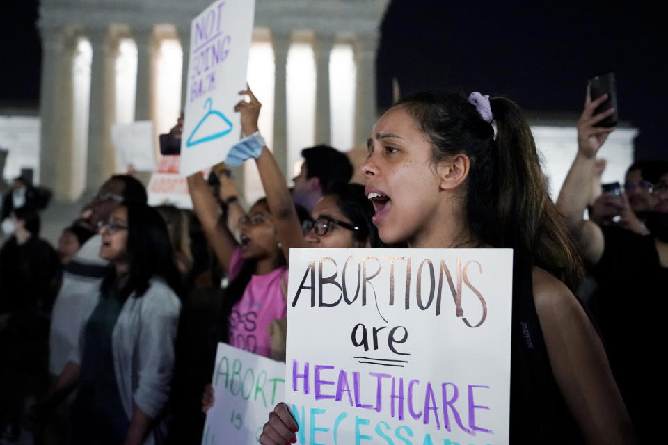 A crowd of people gather outside the Supreme Court, early Tuesday, May 3, 2022 in Washington. A draft opinion circulated among Supreme Court justices suggests that earlier this year a majority of them had thrown support behind overturning the 1973 case Roe v. Wade that legalized abortion nationwide, according to a report published Monday night in Politico. It's unclear if the draft represents the court's final word on the matter. The Associated Press could not immediately confirm the authenticity of the draft Politico posted, which if verified marks a shocking revelation of the high court's secretive deliberation process, particularly before a case is formally decided. (AP Photo/Alex Brandon)